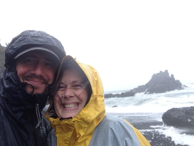 Man and woman on beach in rain